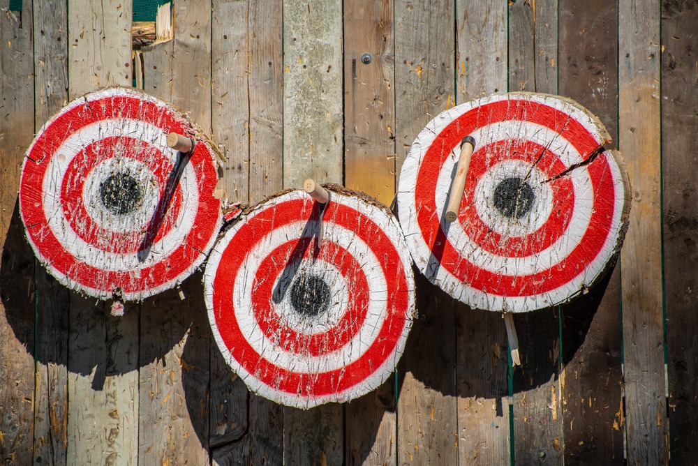 Three archery targets with arrows